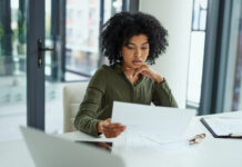 Is There a Policy in the House? Storming Your Insurance Coverage lady sitting at table going over paperwork